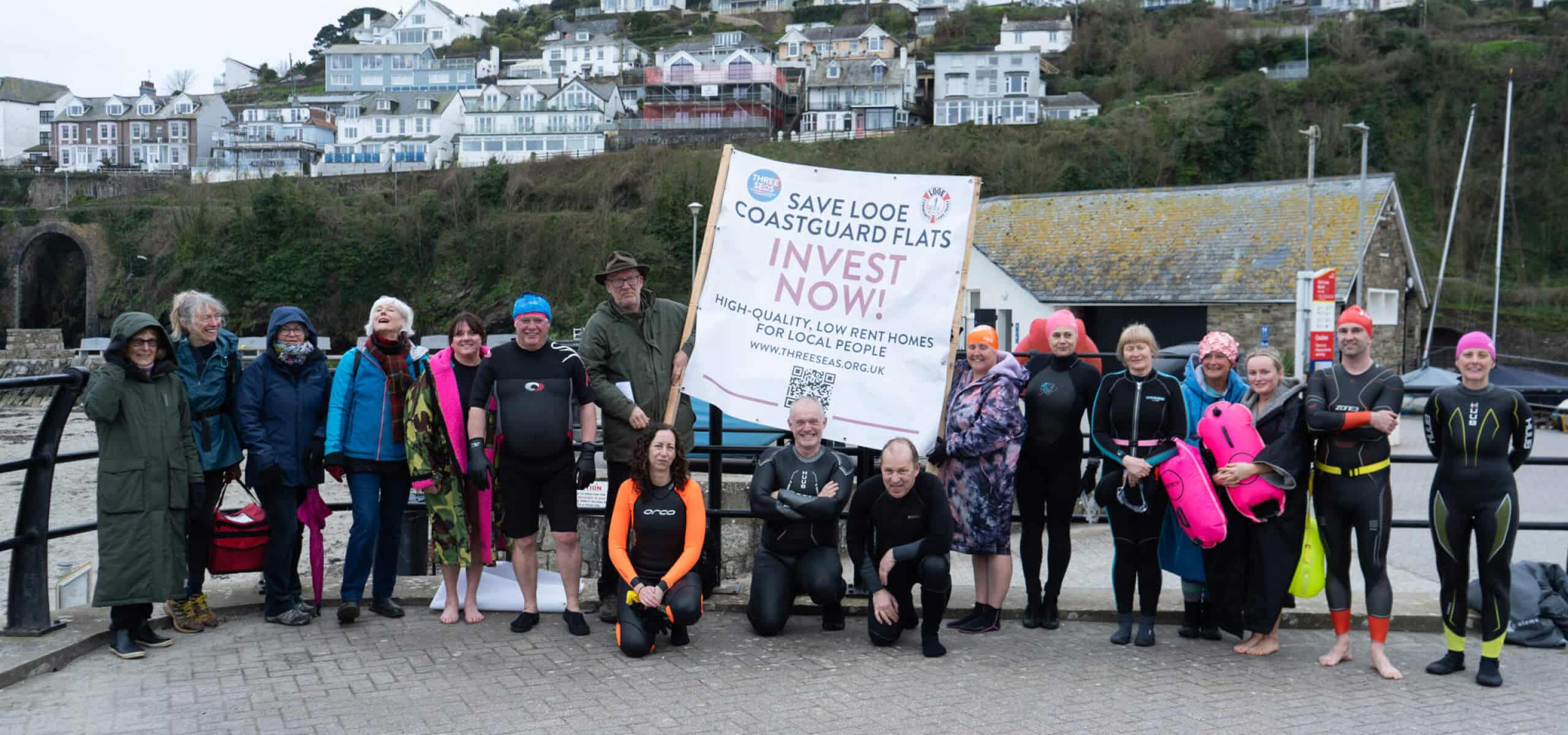 Image of local residents with a banner, trying to save local flats for coast guards in St Ives